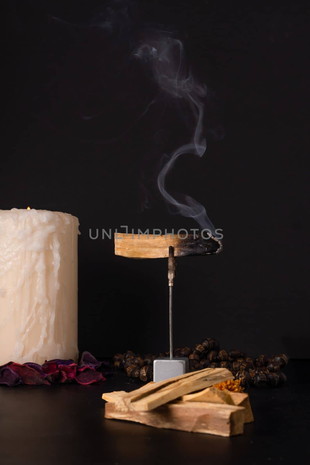 smoking palo santo ,holy stick with candles and japa-mala by joseantona