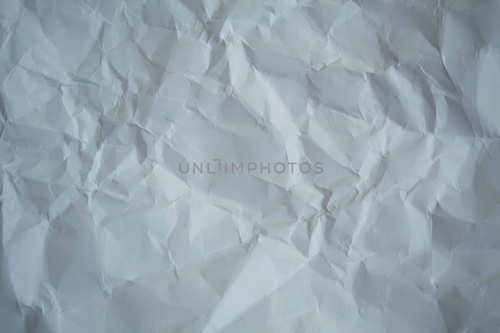 Texture, background. White crumpled paper, close up.