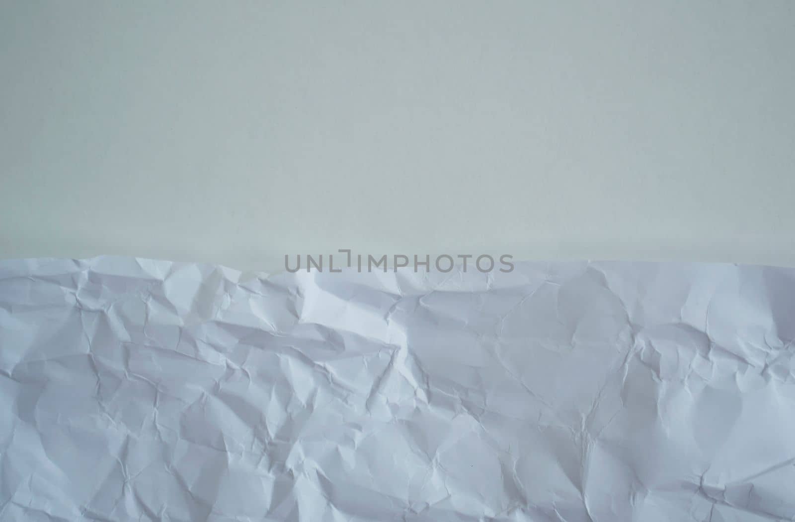 Texture, background. White crumpled paper, close up.