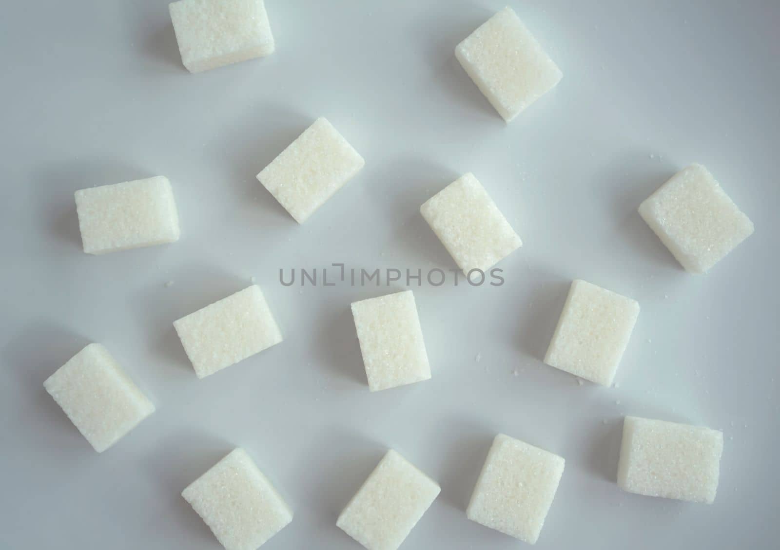 Background, texture, sugar cubes. Sugar in cubes on a white background.