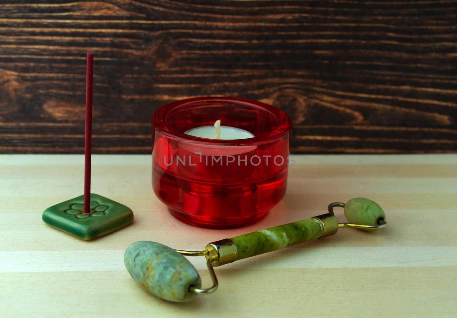 A jade roller, a candle and an incense stick by Yuka777