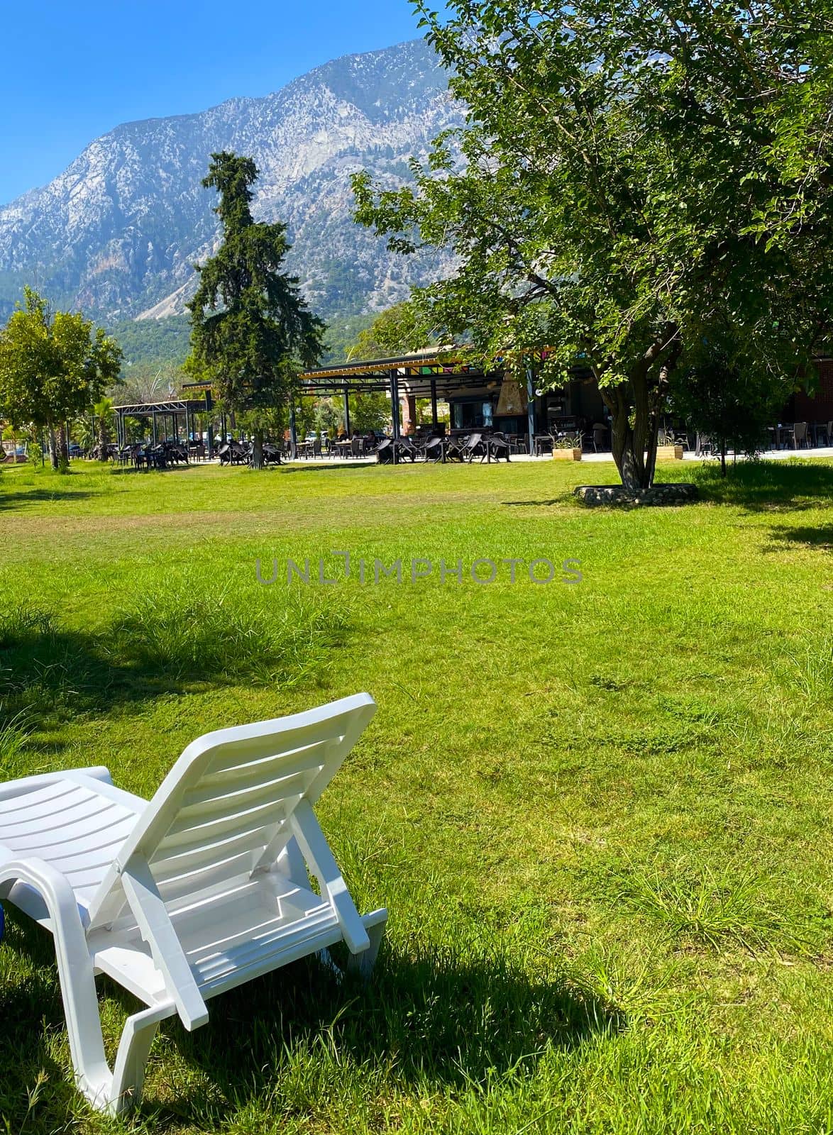 Turkey Kemer. View of the park and mountains, in the foreground a deck chair.