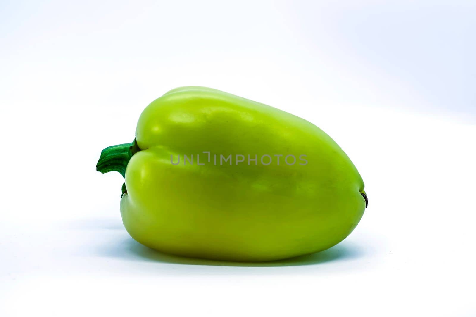 Green pepper on a white background close-up.