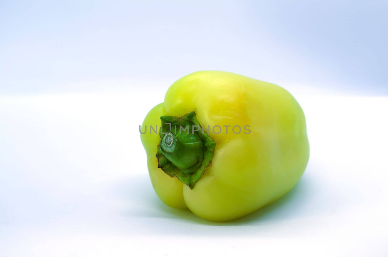 
Green pepper on a white background close-up.