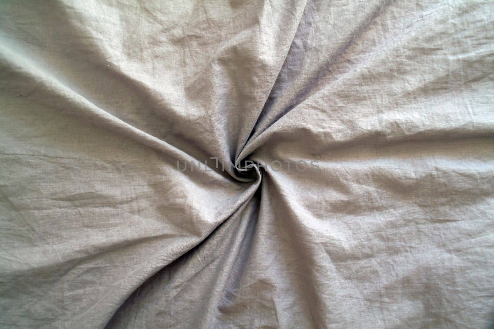 
Background, texture, gray wrinkled fabric, cotton. Photo of a gray crumpled fabric in the form of a spiral.