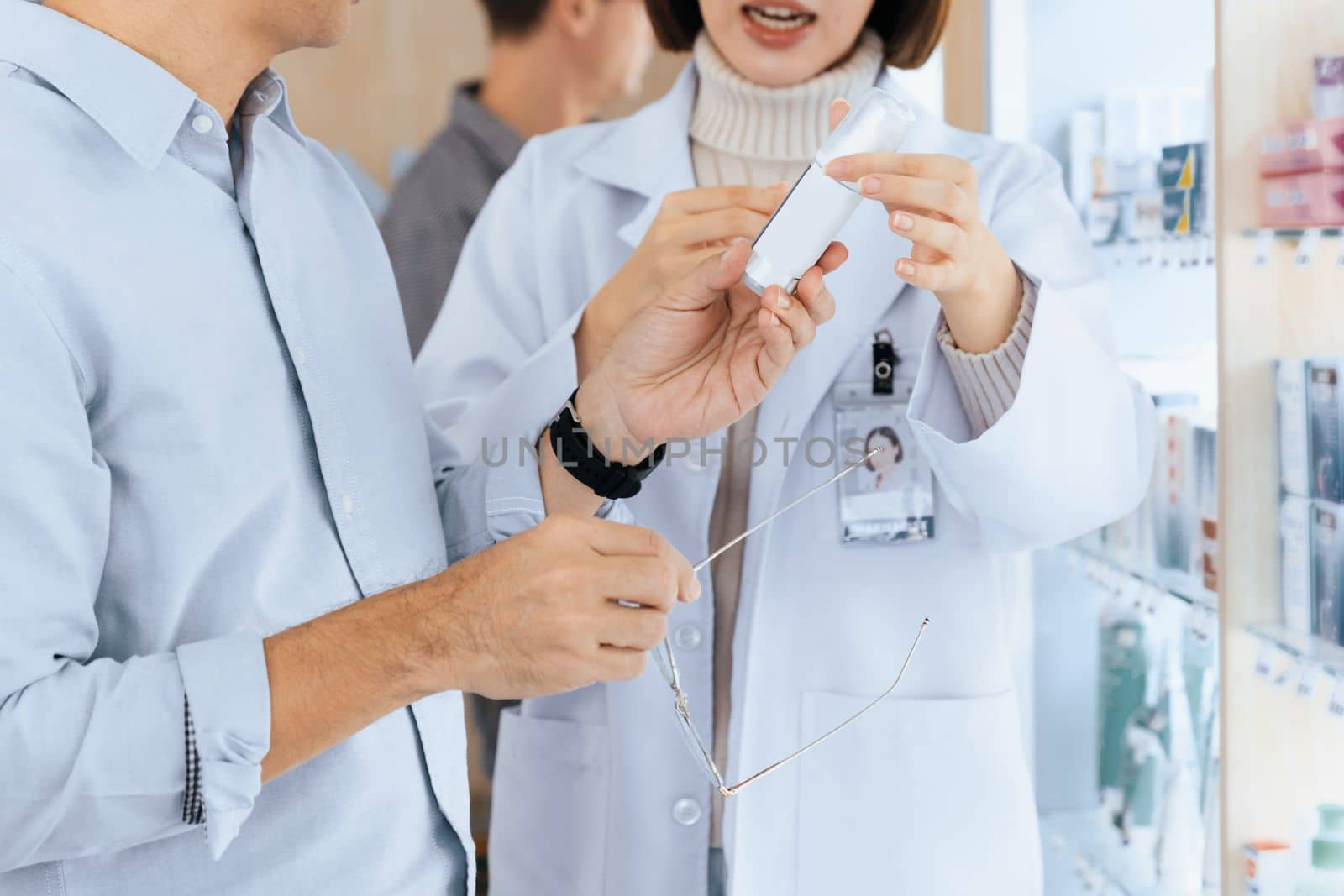 Closeup professional pharmacist advise or explain property of qualified medical product to customer in pharmacy, druggist answer to client healthcare inquiry, medical service and consultation concept.