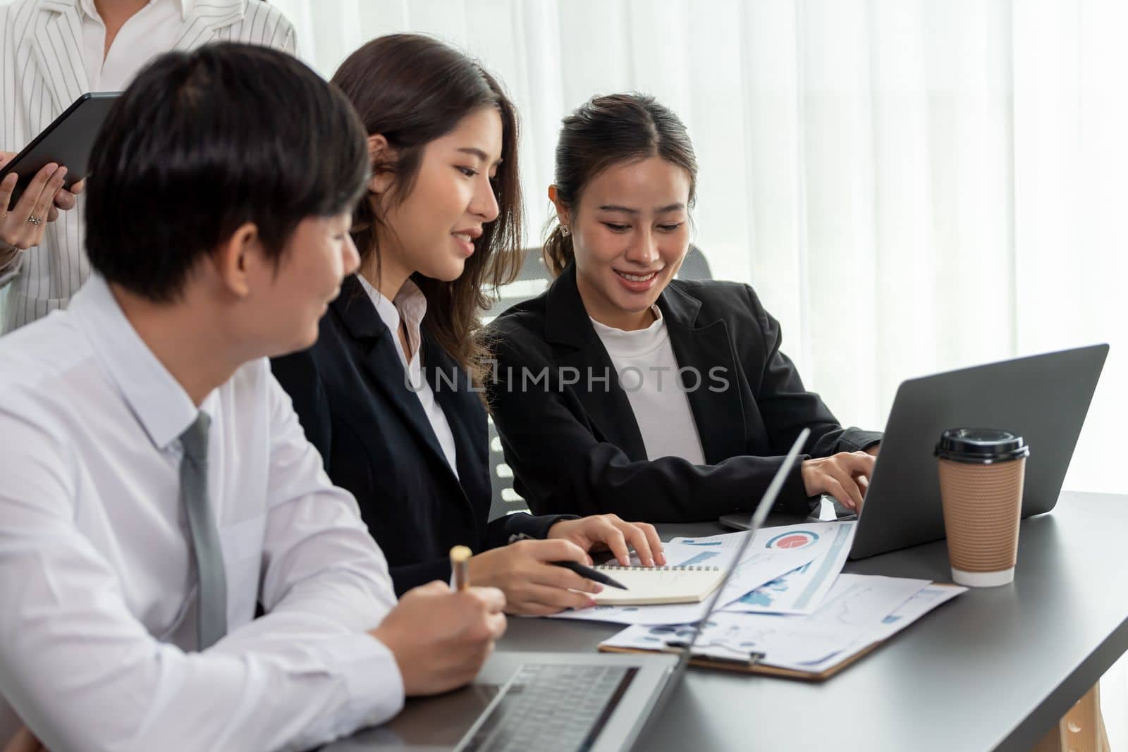 Office worker and manager analyze financial report paper in harmony workplace. by biancoblue