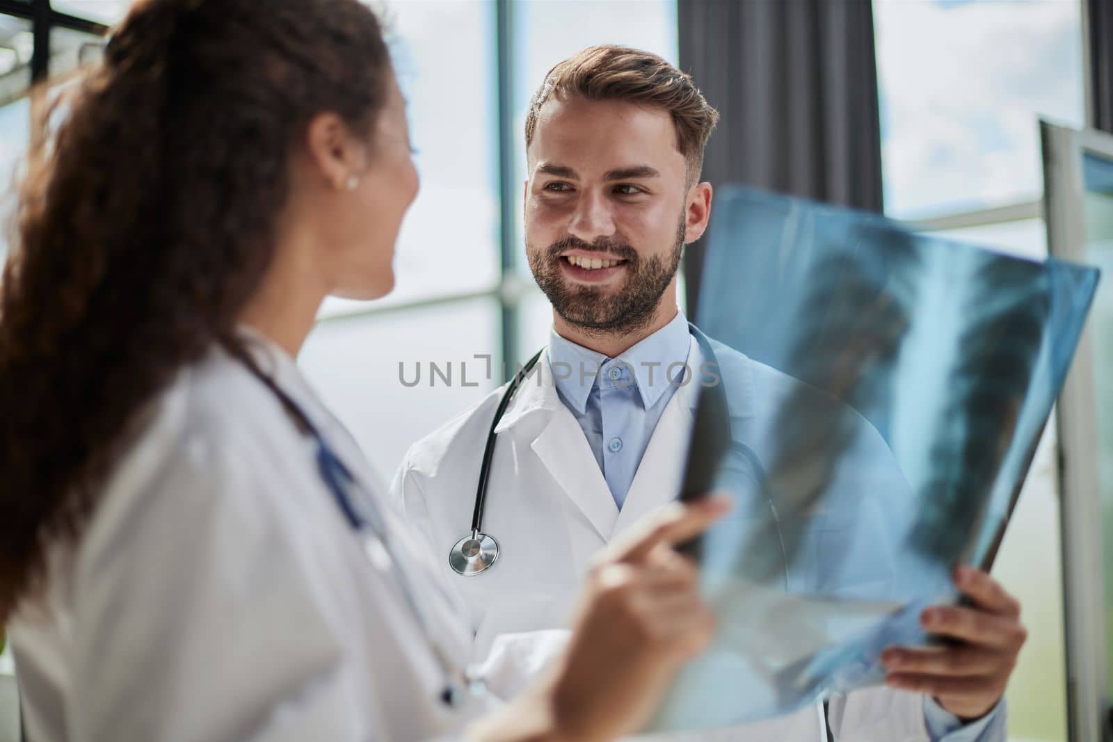 Concentrated male doctor looking at x-ray picture of spine