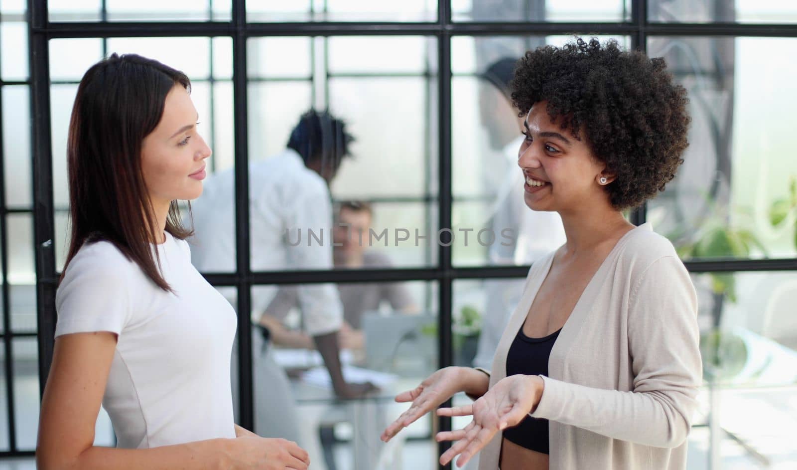 Two women analyzing documents office. Woman executives at work in office discussing some paperwork. by Prosto