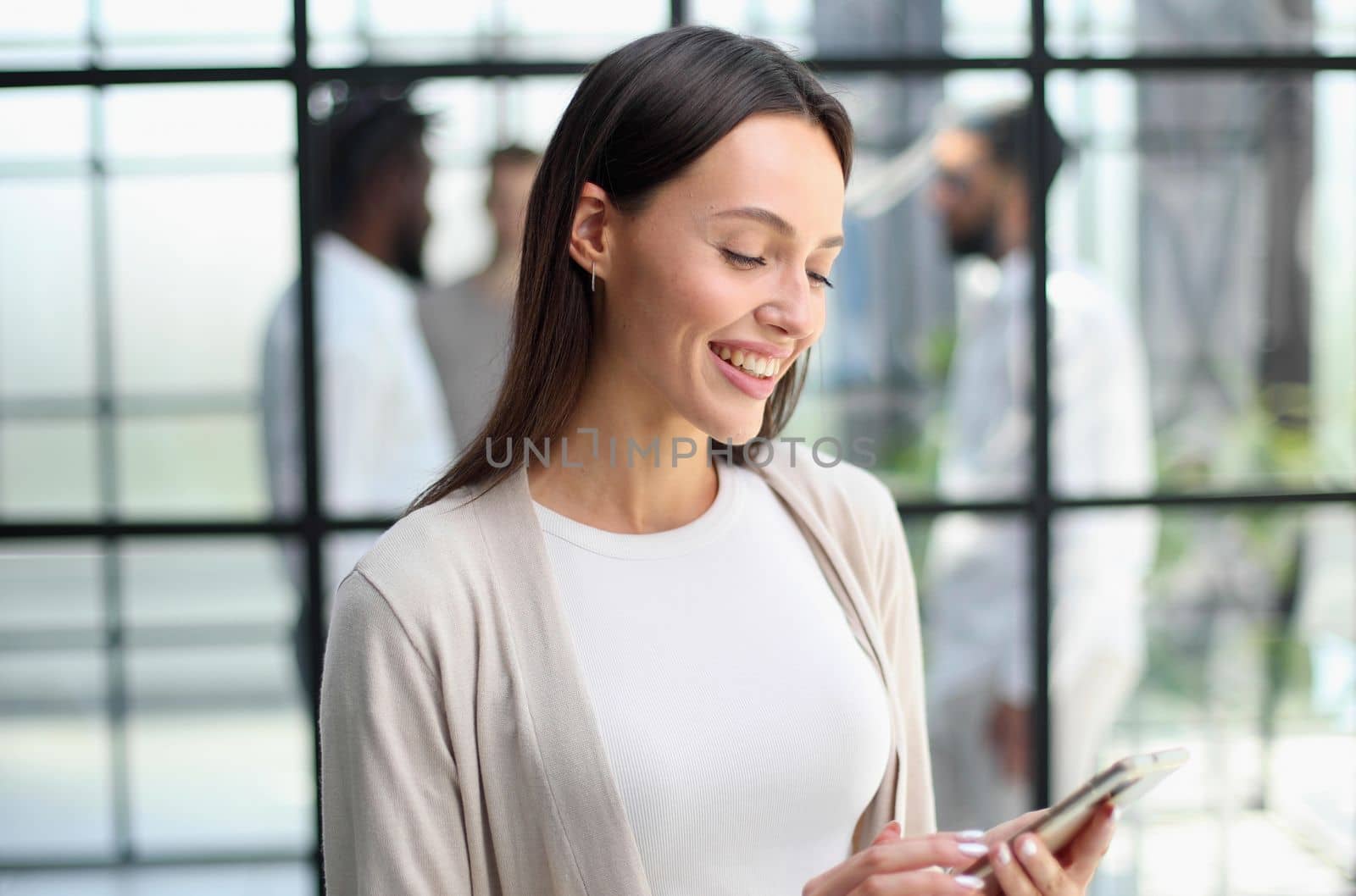 Businesswoman sitting in office, talking on the phone