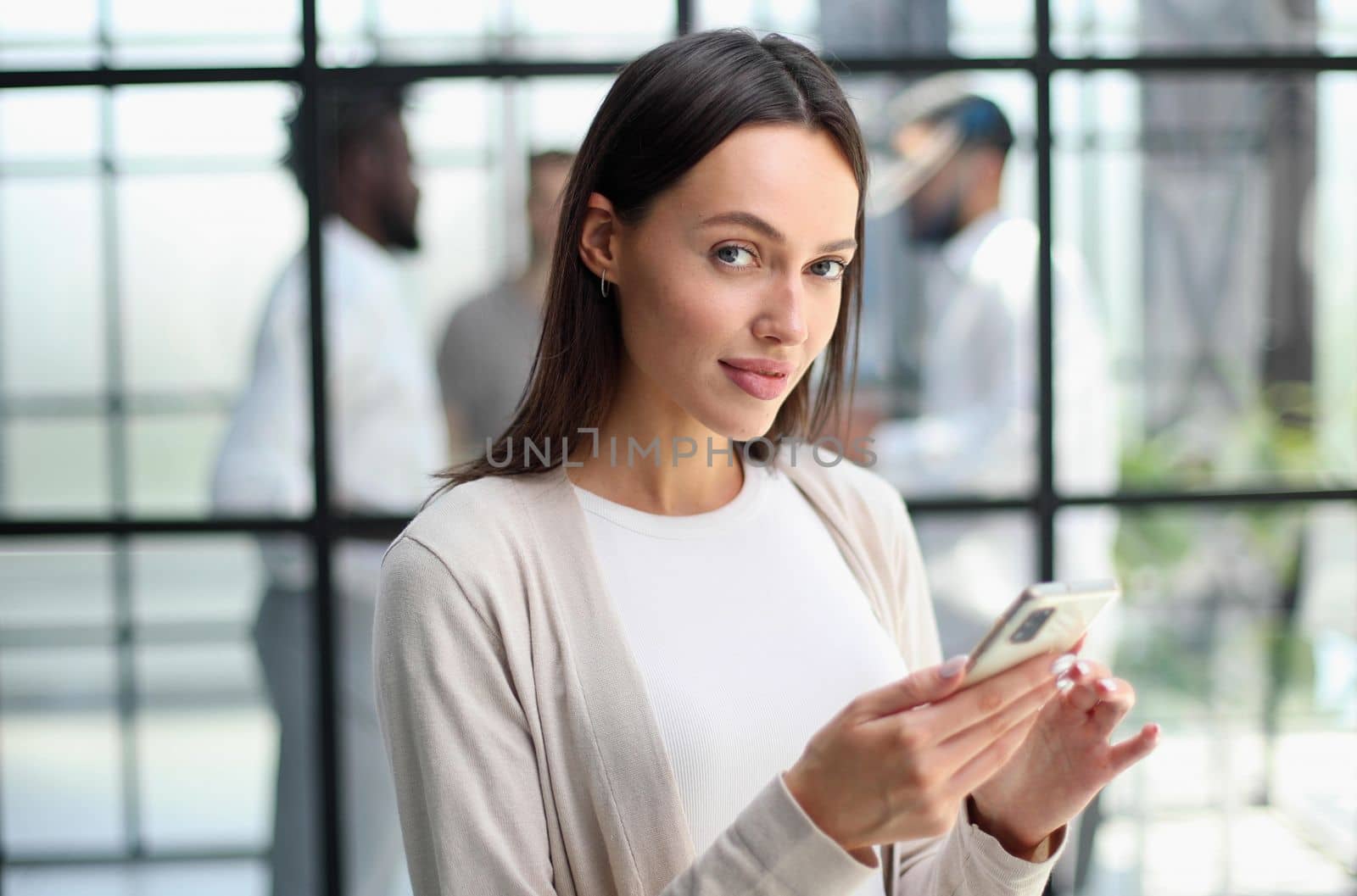 Businesswoman sitting in office, talking on the phone