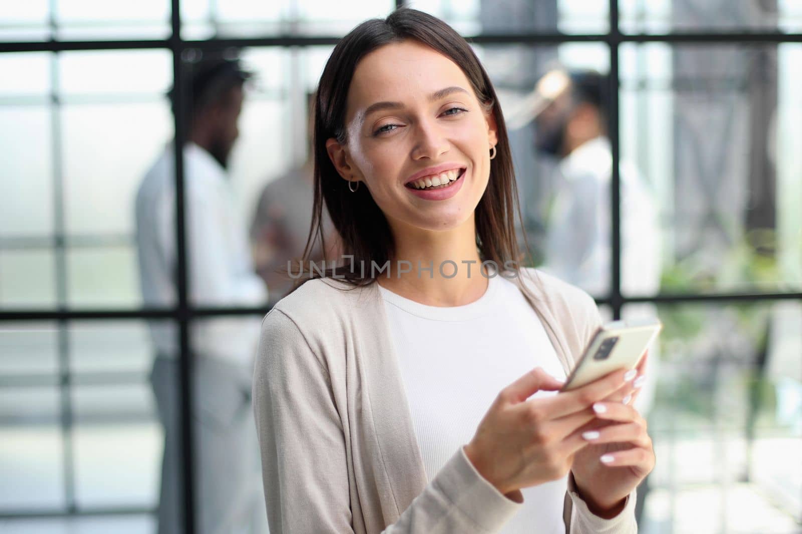 Businesswoman sitting in office, talking on the phone