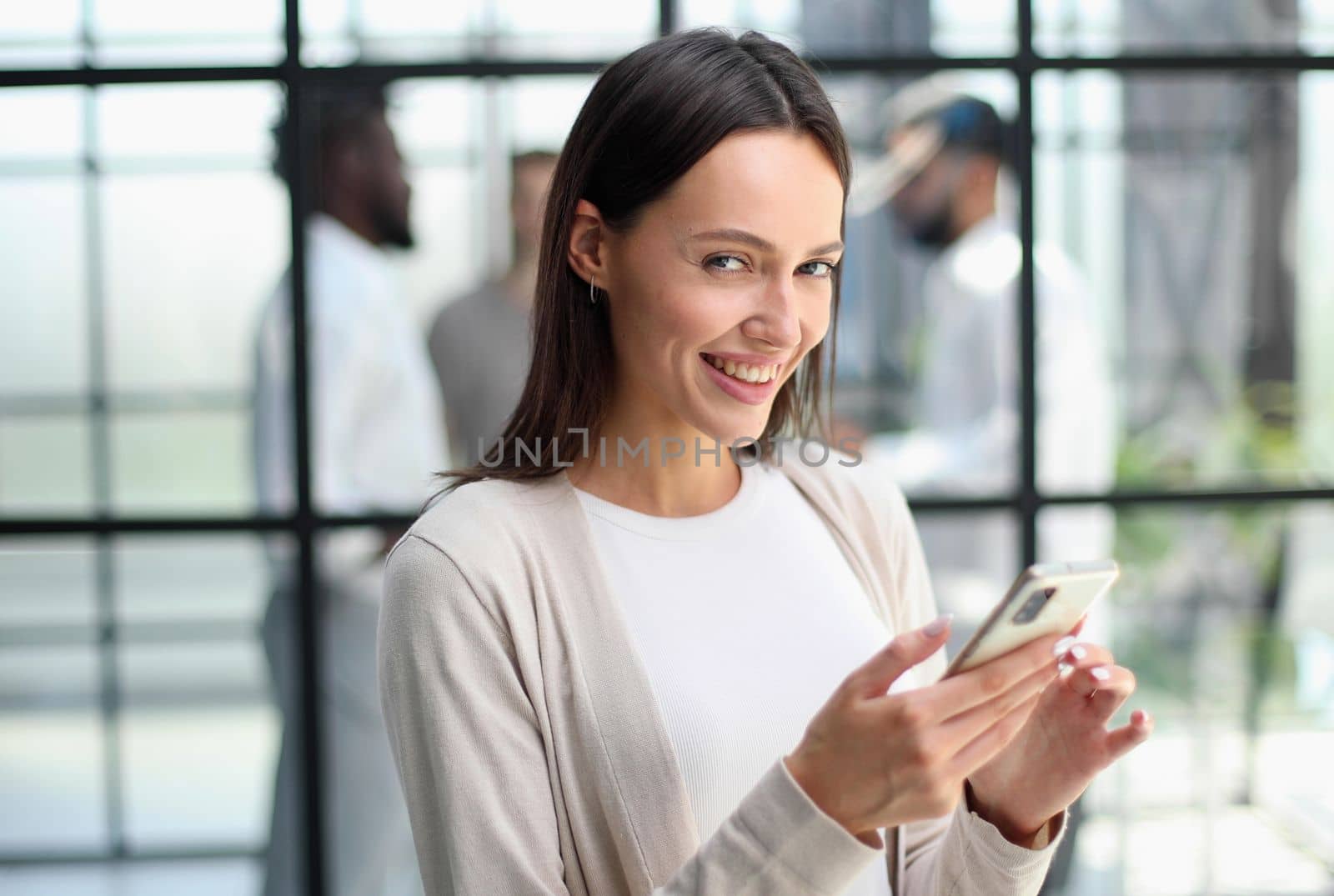 Businesswoman sitting in office, talking on the phone