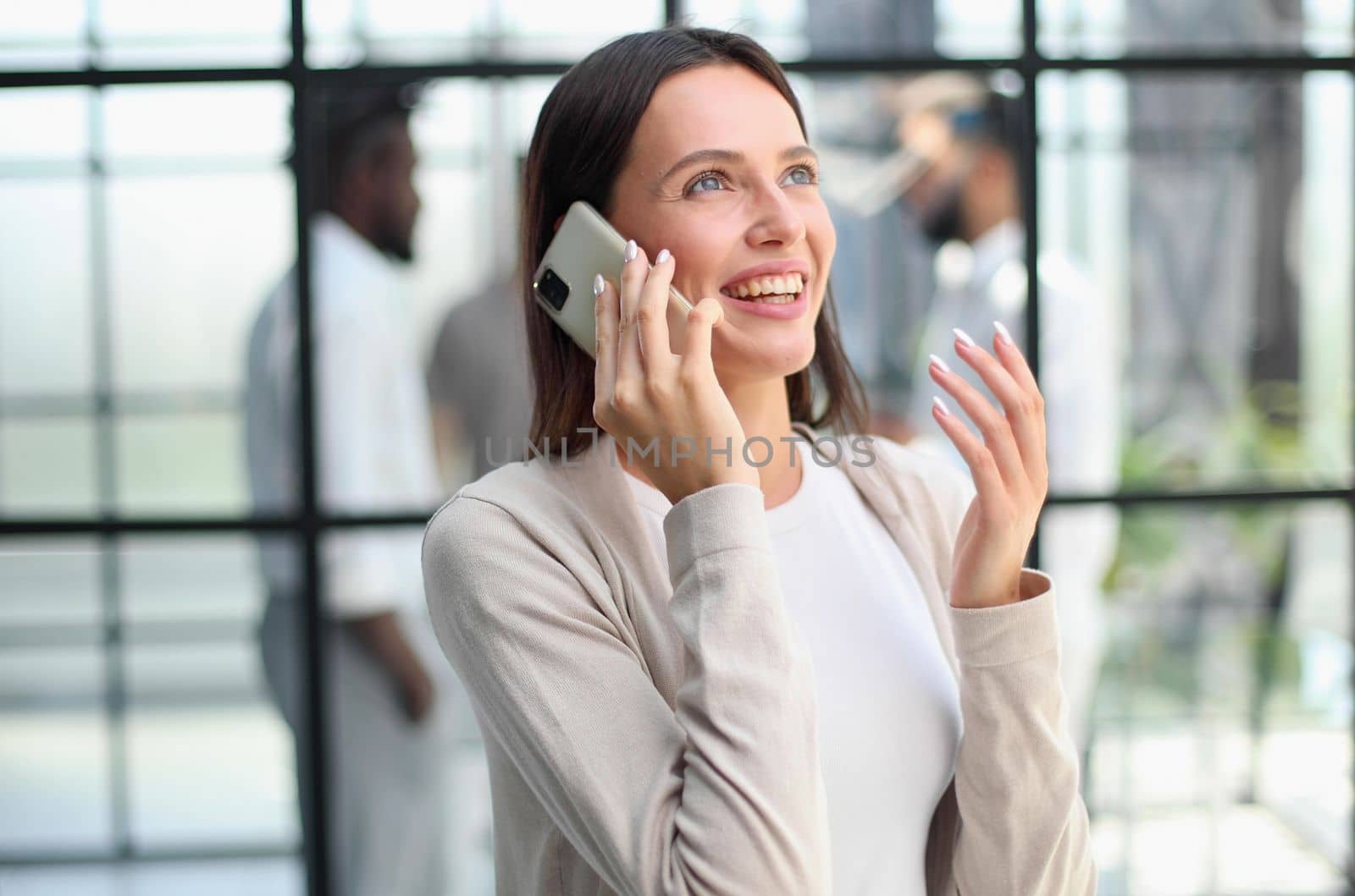 Businesswoman sitting in office, talking on the phone