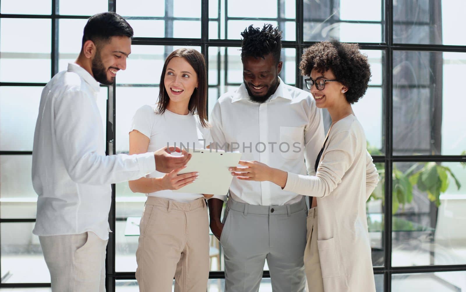 Employees working at computer together, discussing content by Prosto