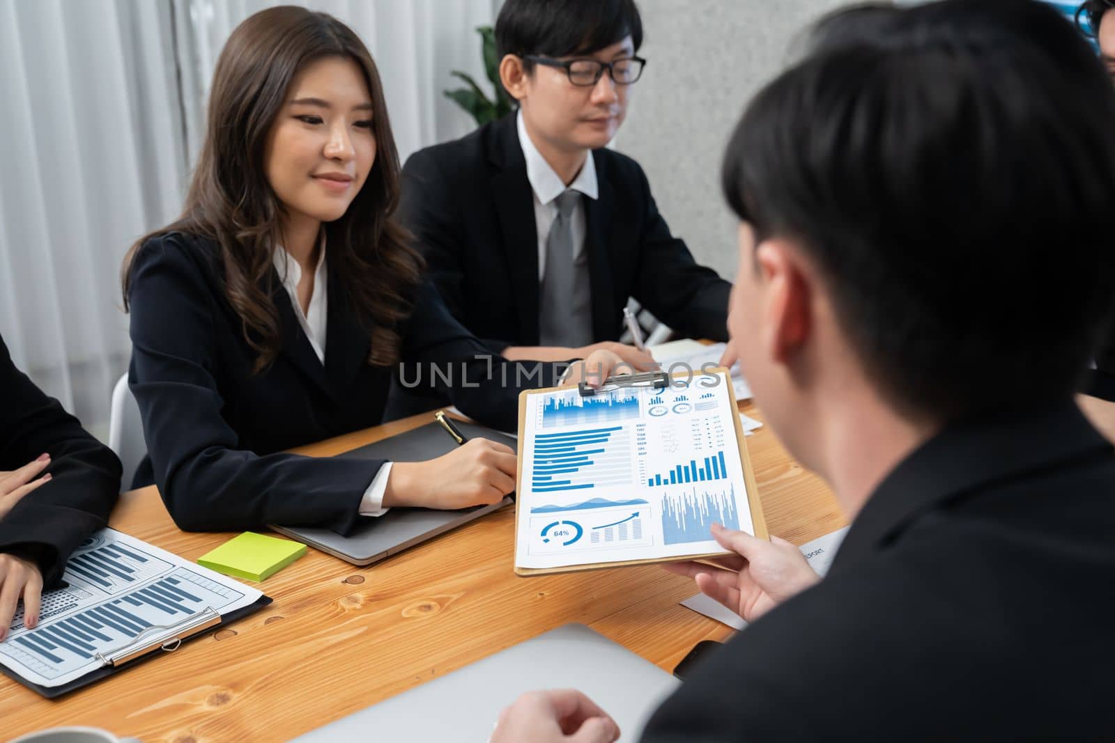 Business team of financial data analysis meeting with business intelligence, report paper and dashboard on laptop for marketing strategy. Business people working together to promote harmony in office.