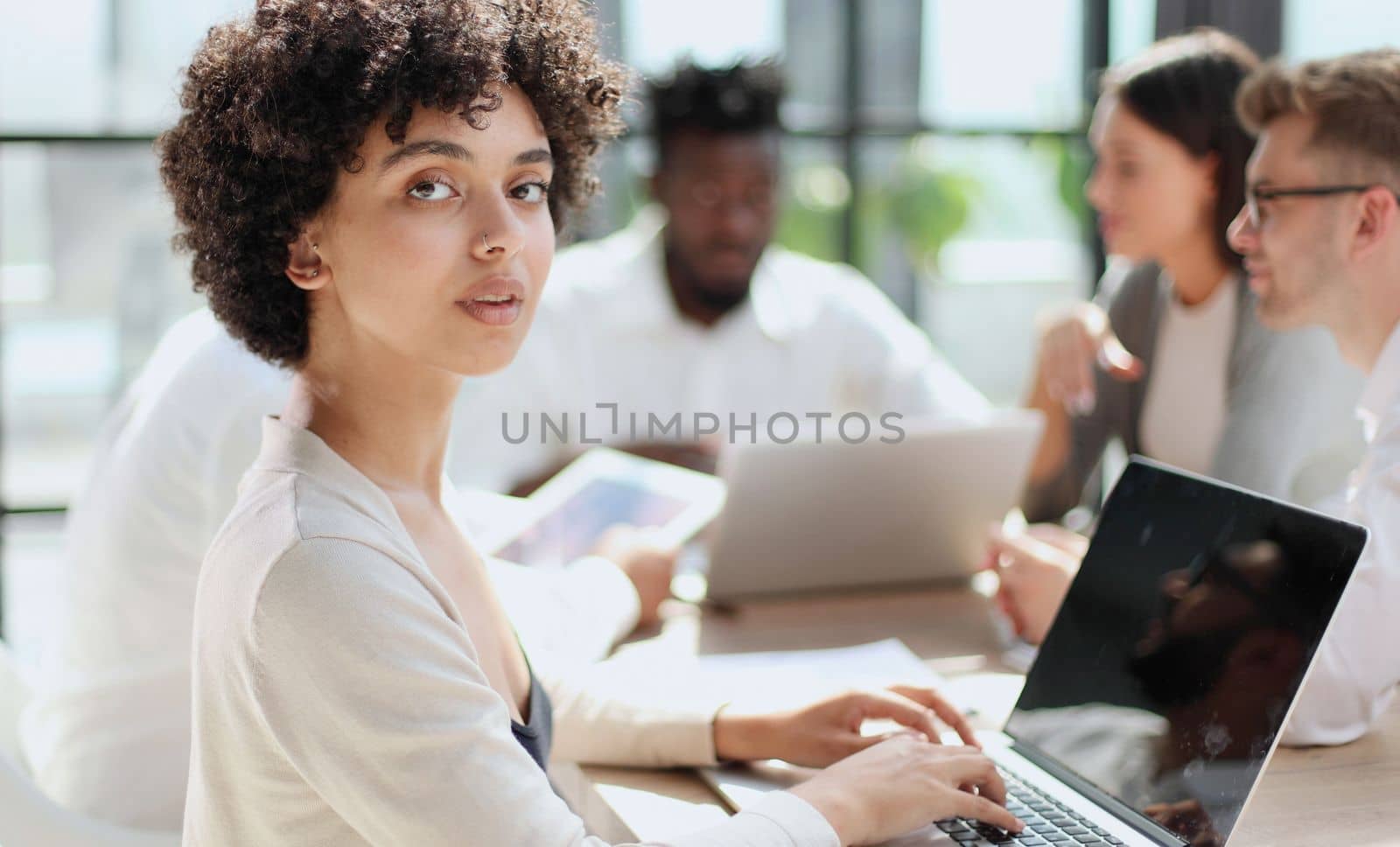 Face of beautiful woman on the background of business people