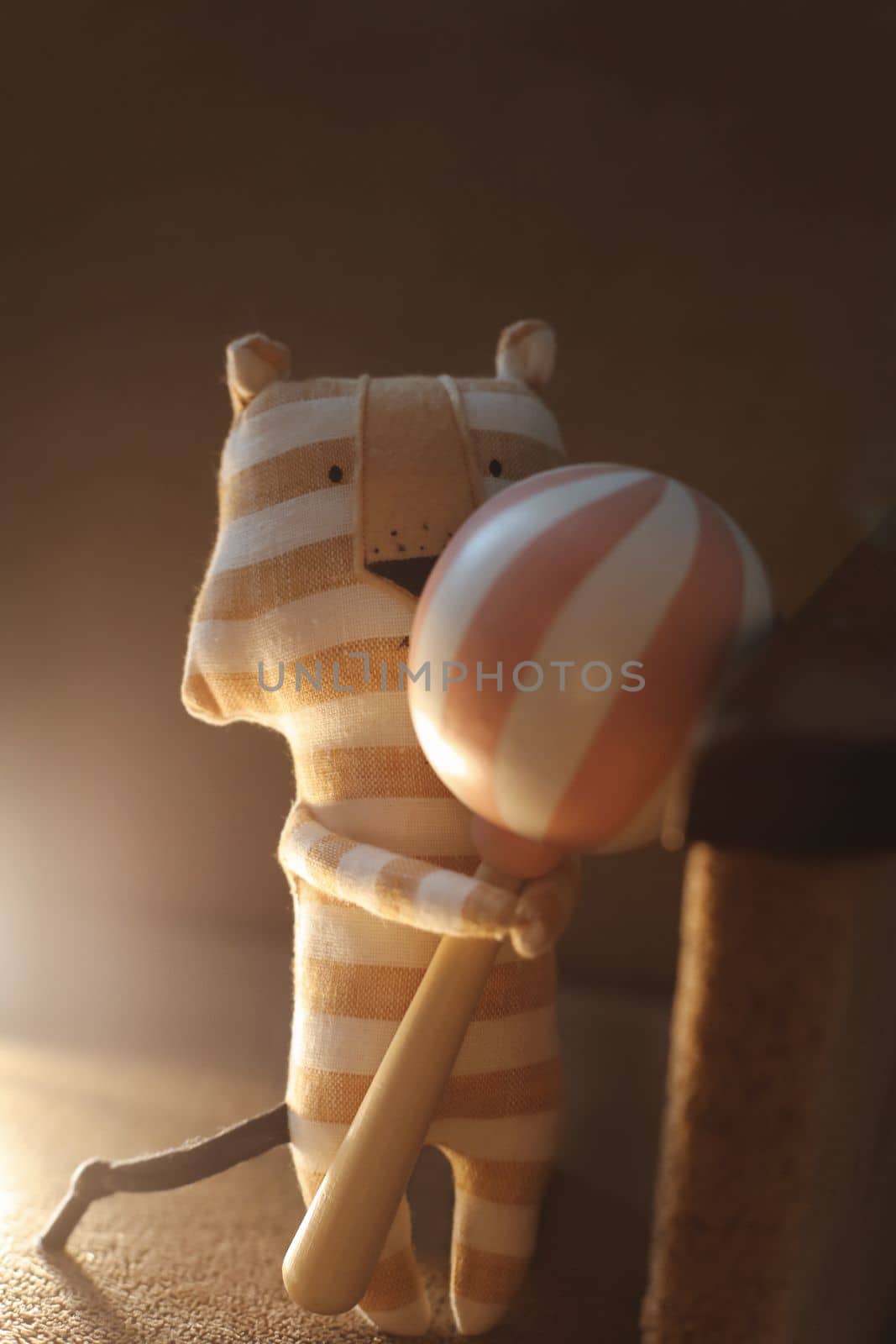 Toys made of natural materials. Tiger plush toy on cozy background. Non-plastic, eco-friendly, handmade toys for children