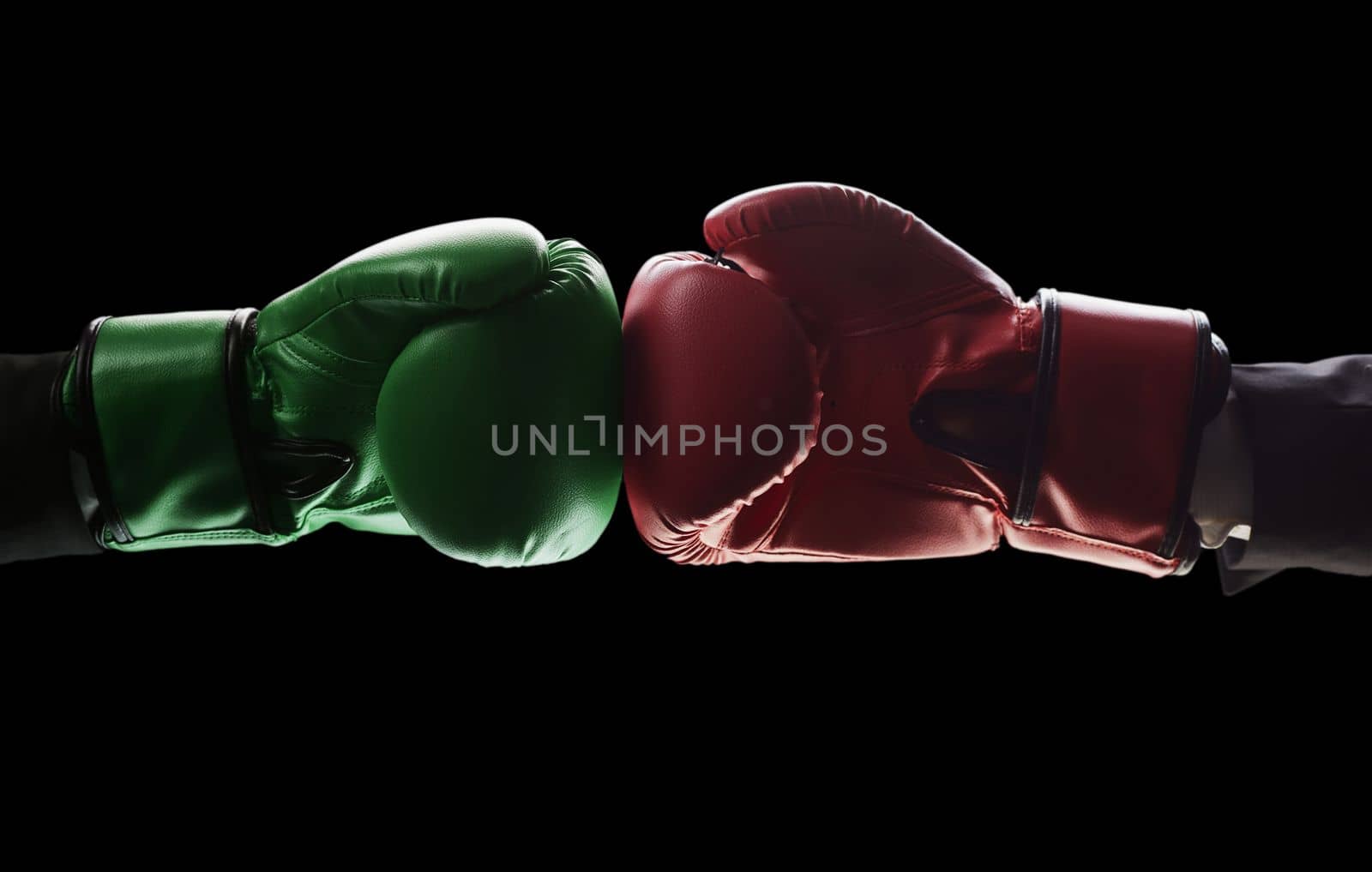 Two men's hands in boxing gloves. The concept of confrontation. Photo on a black background by Prosto