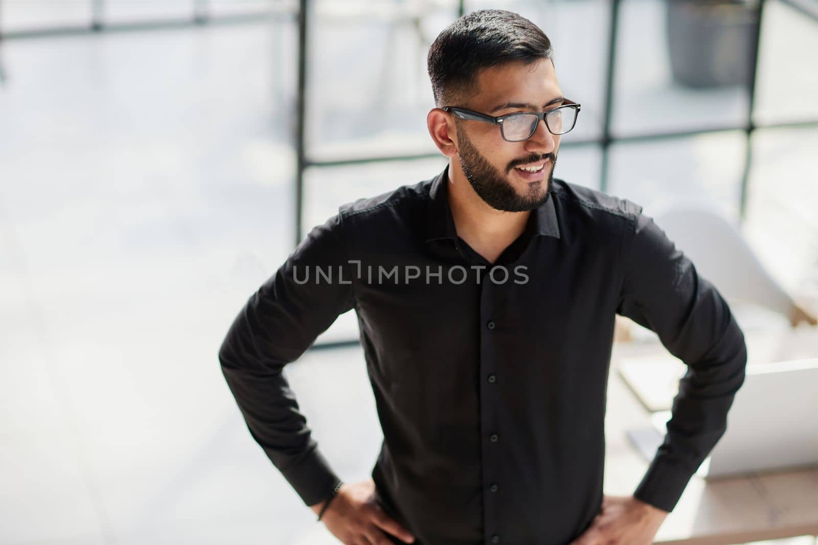 Businessman portrait. Happy confident young businessman standing , smiling, looking at camera.