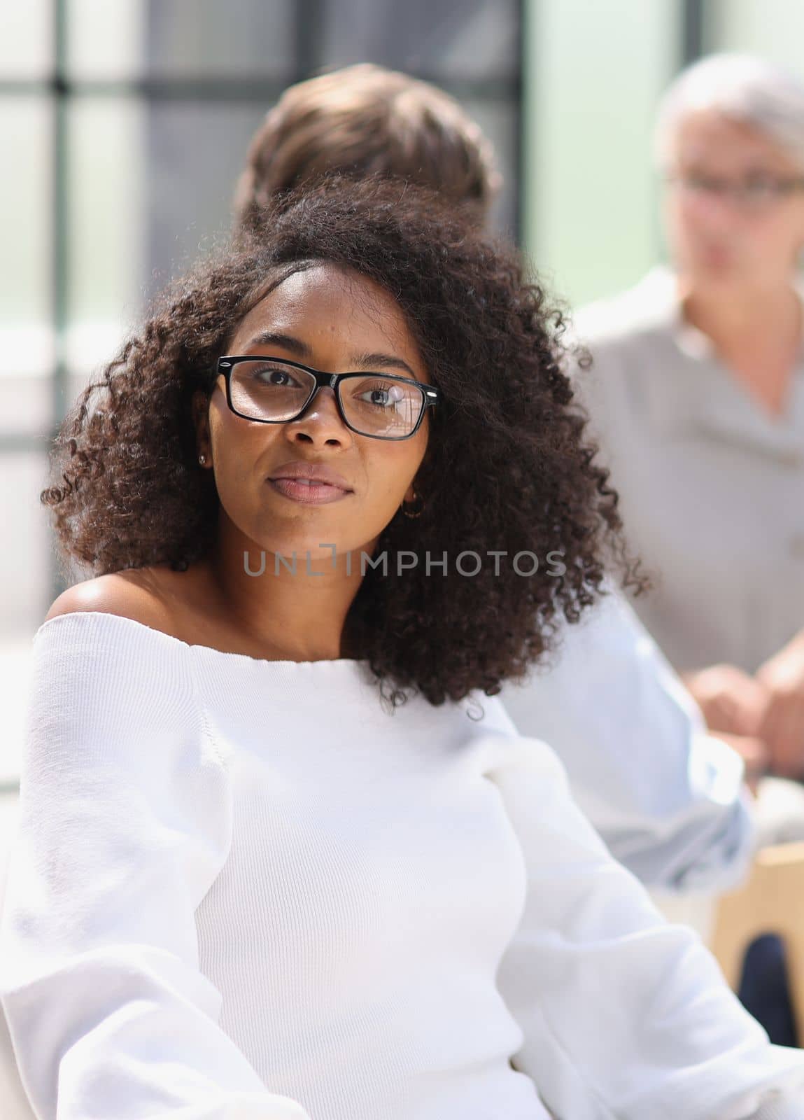 portrait of a young african american woman in the office at the table by Prosto