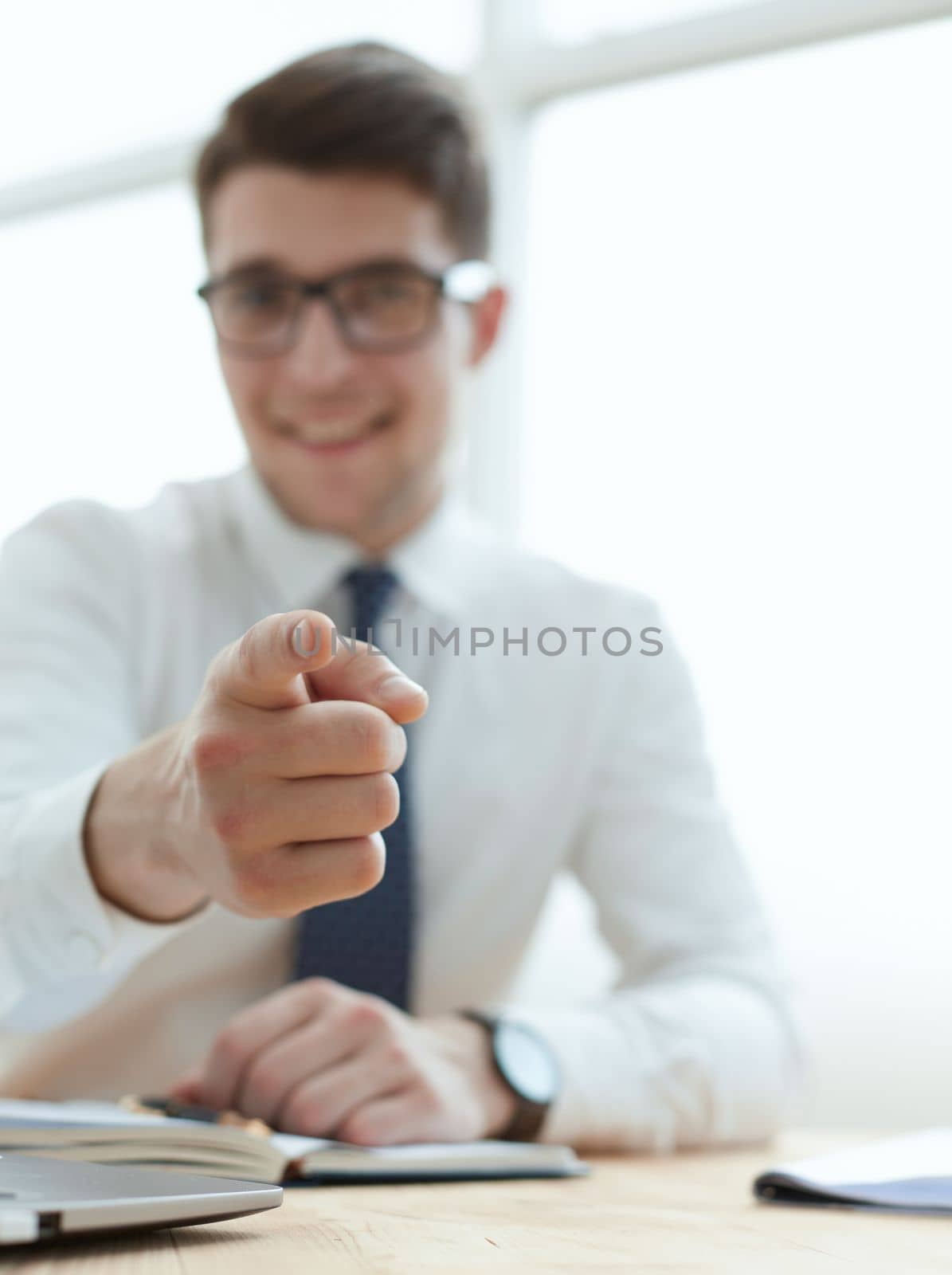 Handsome smiling businessman pointing his finger to you by Prosto