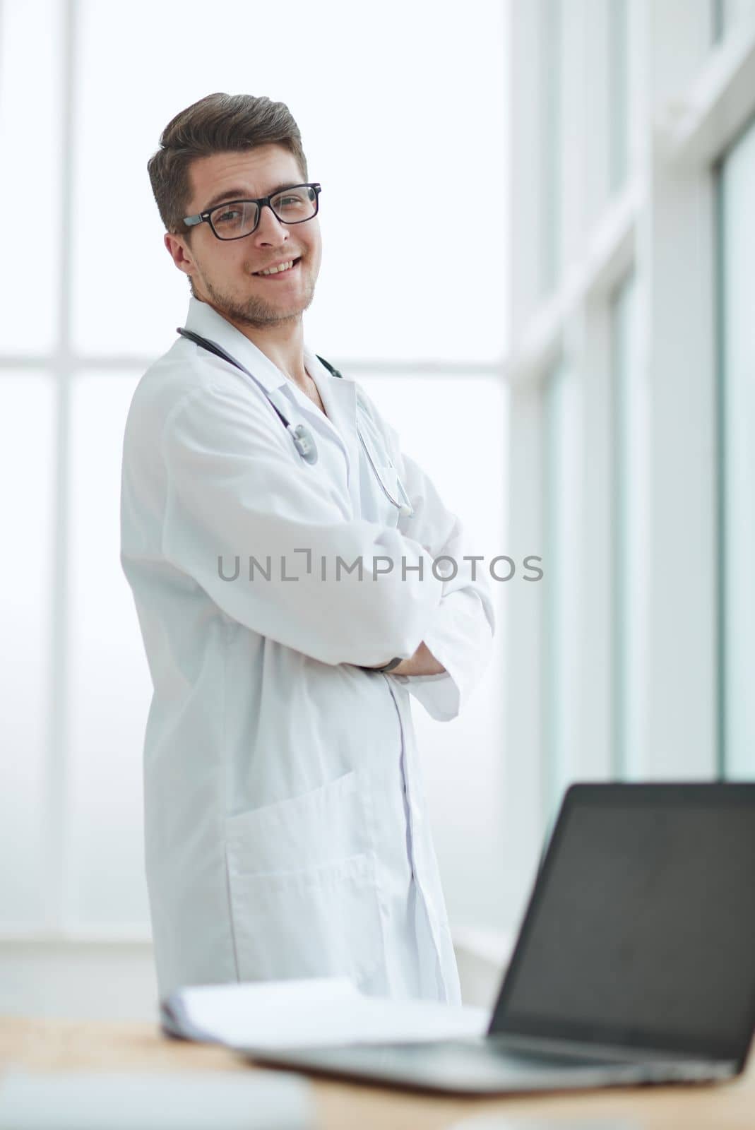 Portrait of young, doctor sitting in medical office