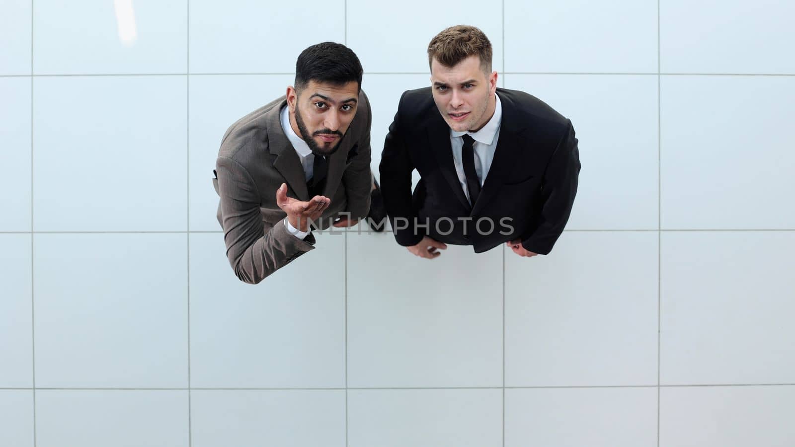 Portrait of two concentrated businessmen partners dressed in formal suit by Prosto