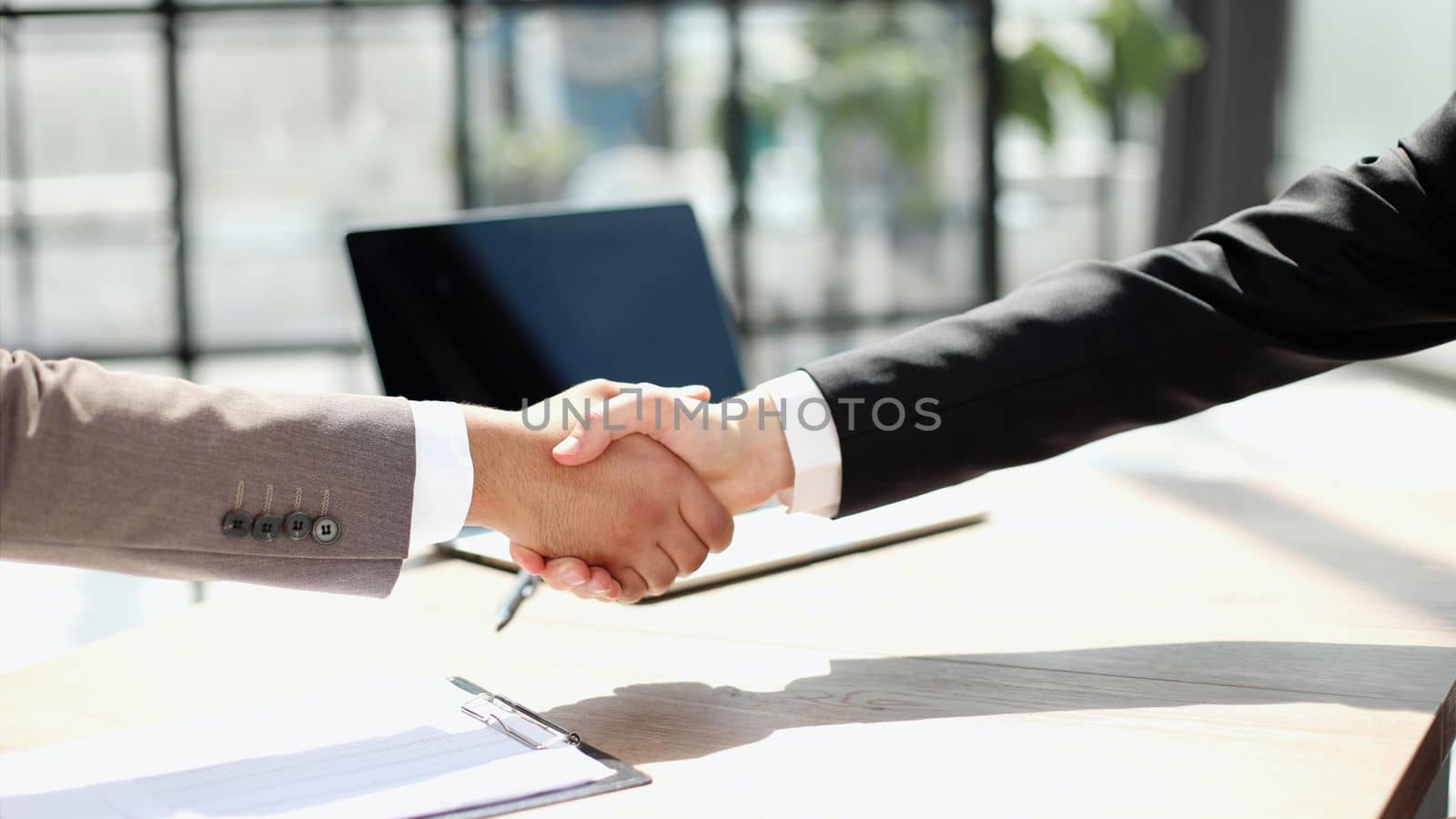 Business shaking hands, finishing up meeting. Successful businessmen handshaking after good deal. by Prosto