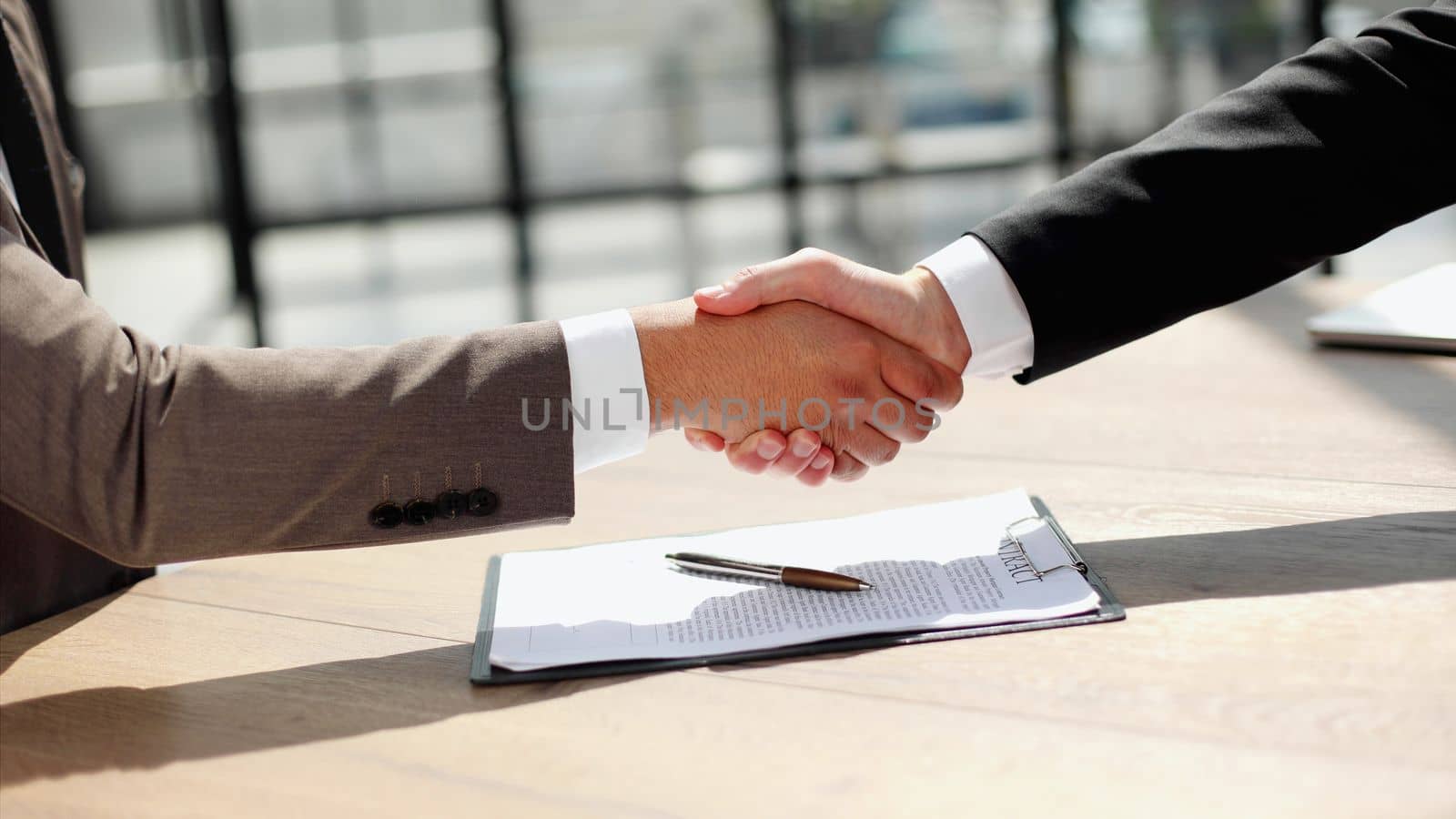Business shaking hands, finishing up meeting. Successful businessmen handshaking after good deal. by Prosto