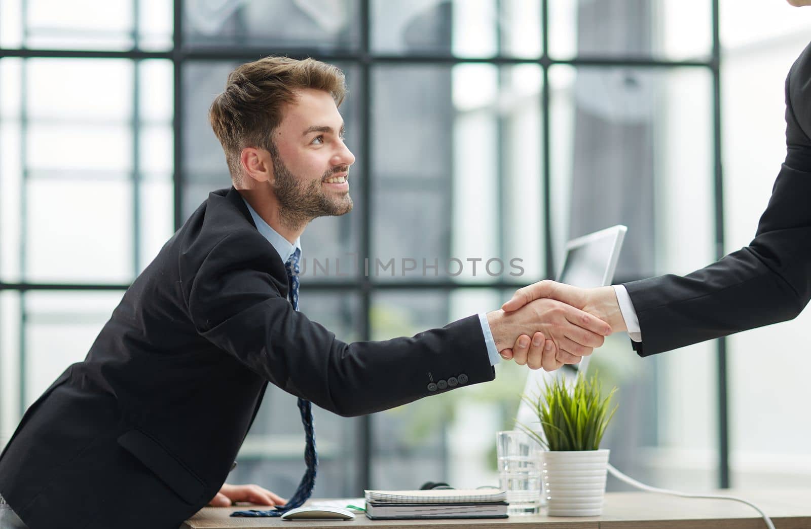businessman handshake for teamwork of business merger and acquisition