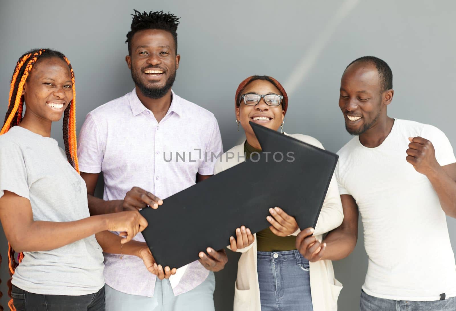 Young african american friends holding black arrow by Prosto