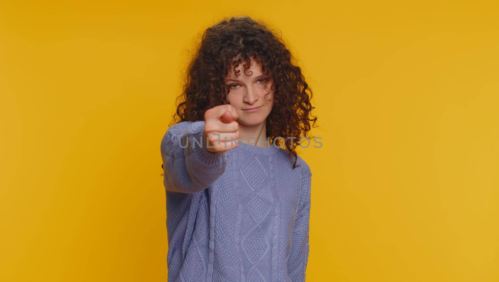 Angry aggressive young woman showing fig negative gesture, you dont get it anyway. Rapacious, avaricious, acquisitive. Body language. Refusal fig sign. Greedy avaricious girl on yellow background