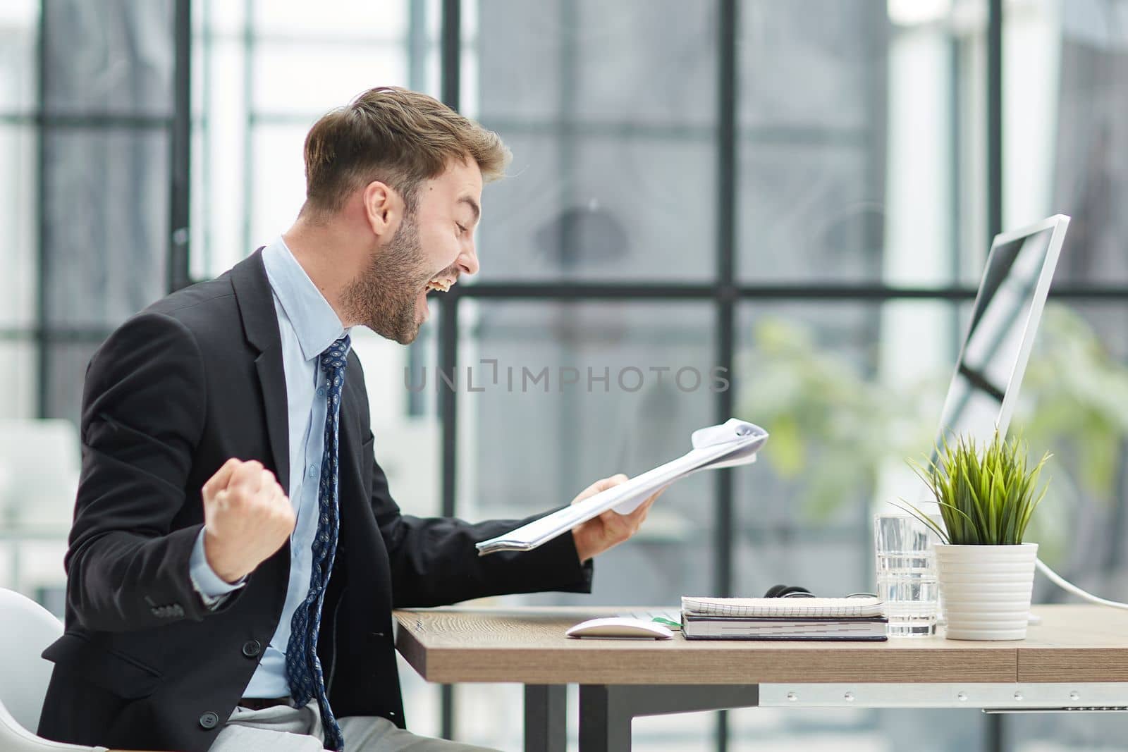 energetic businessman celebrating in office