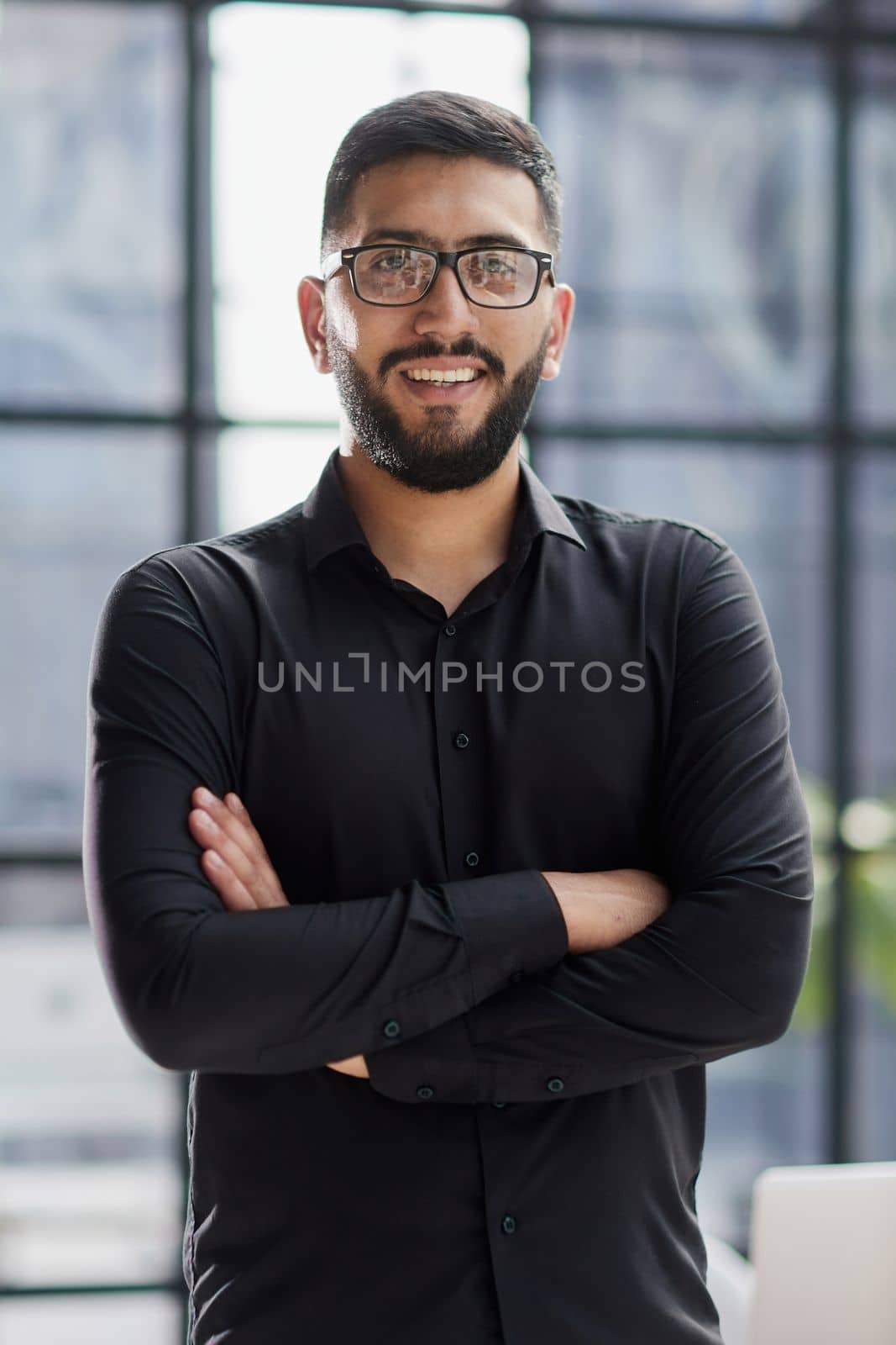 portrait of a young businessman who is smiling by Prosto