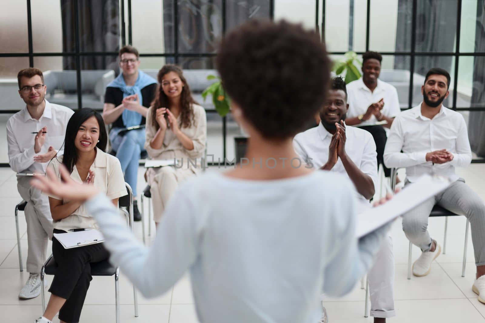 Selective focus of young businesswoman together with interracial colleagues during seminar