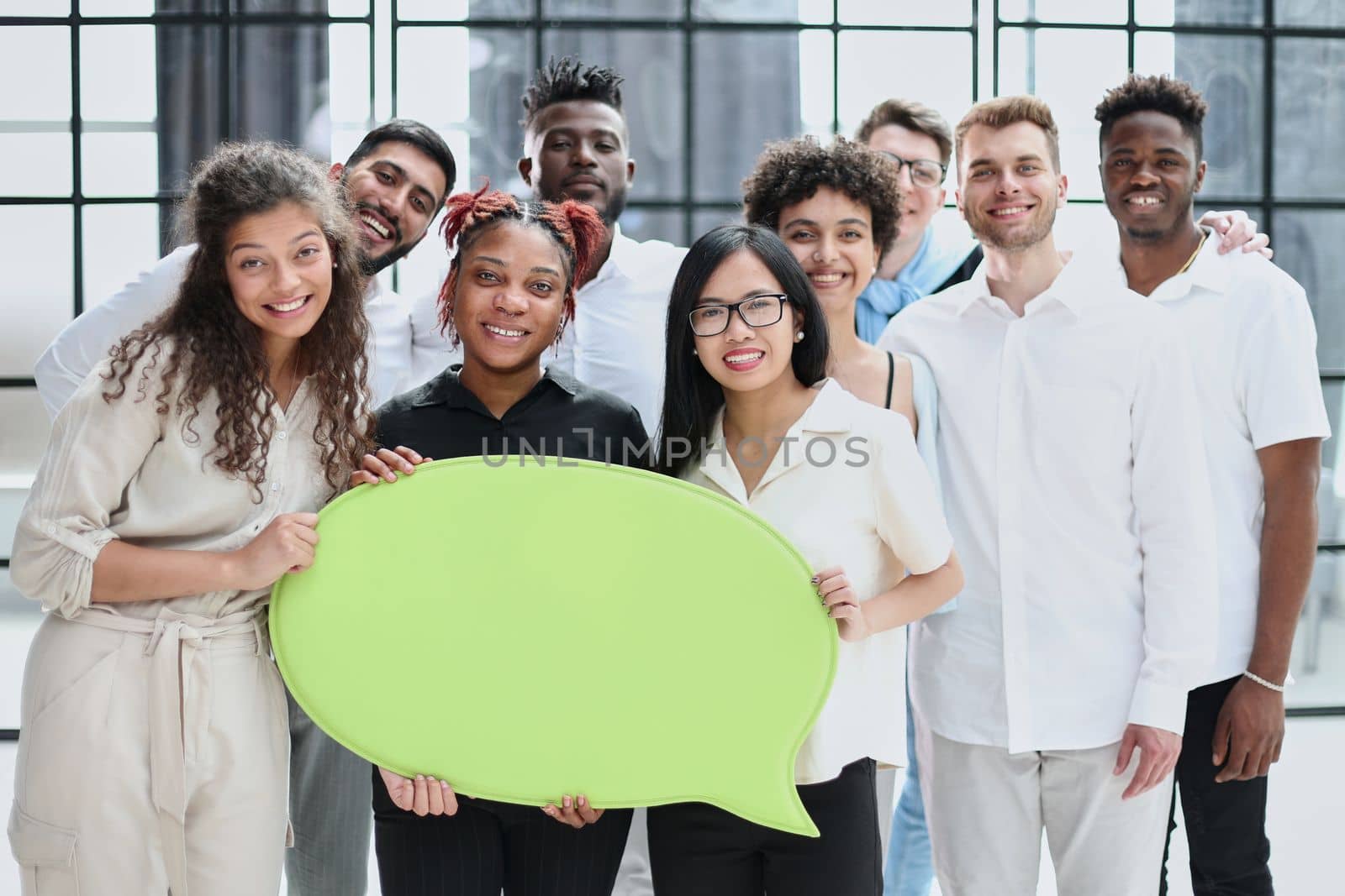 Business team consisting of young business people standing with a comment