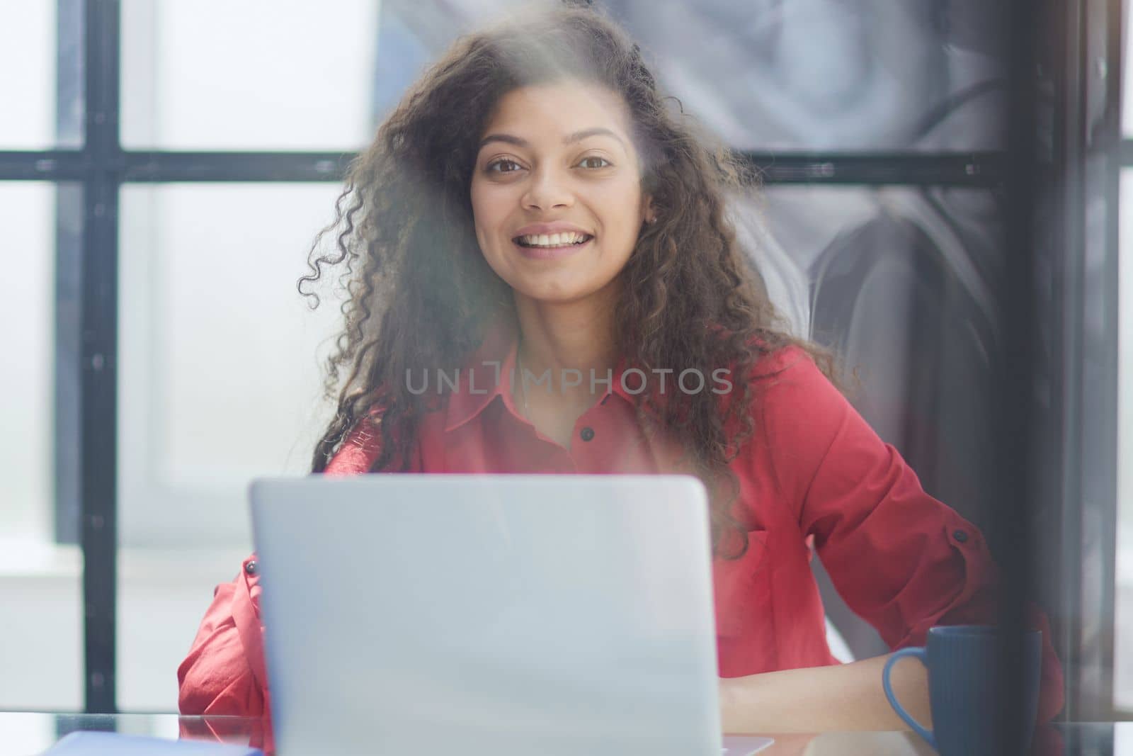 Portrait of Young Successful Caucasian Businesswoman Sitting at Desk Working on Laptop Computer in City Office