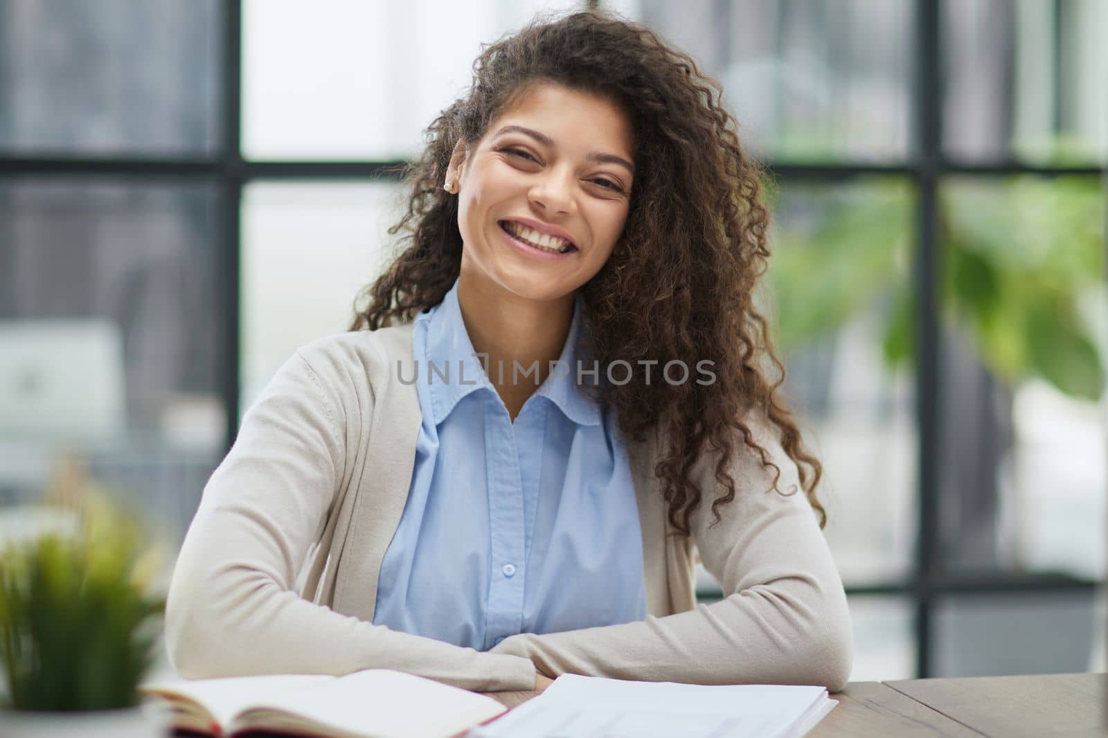 Image of young beautiful joyful woman smiling while working