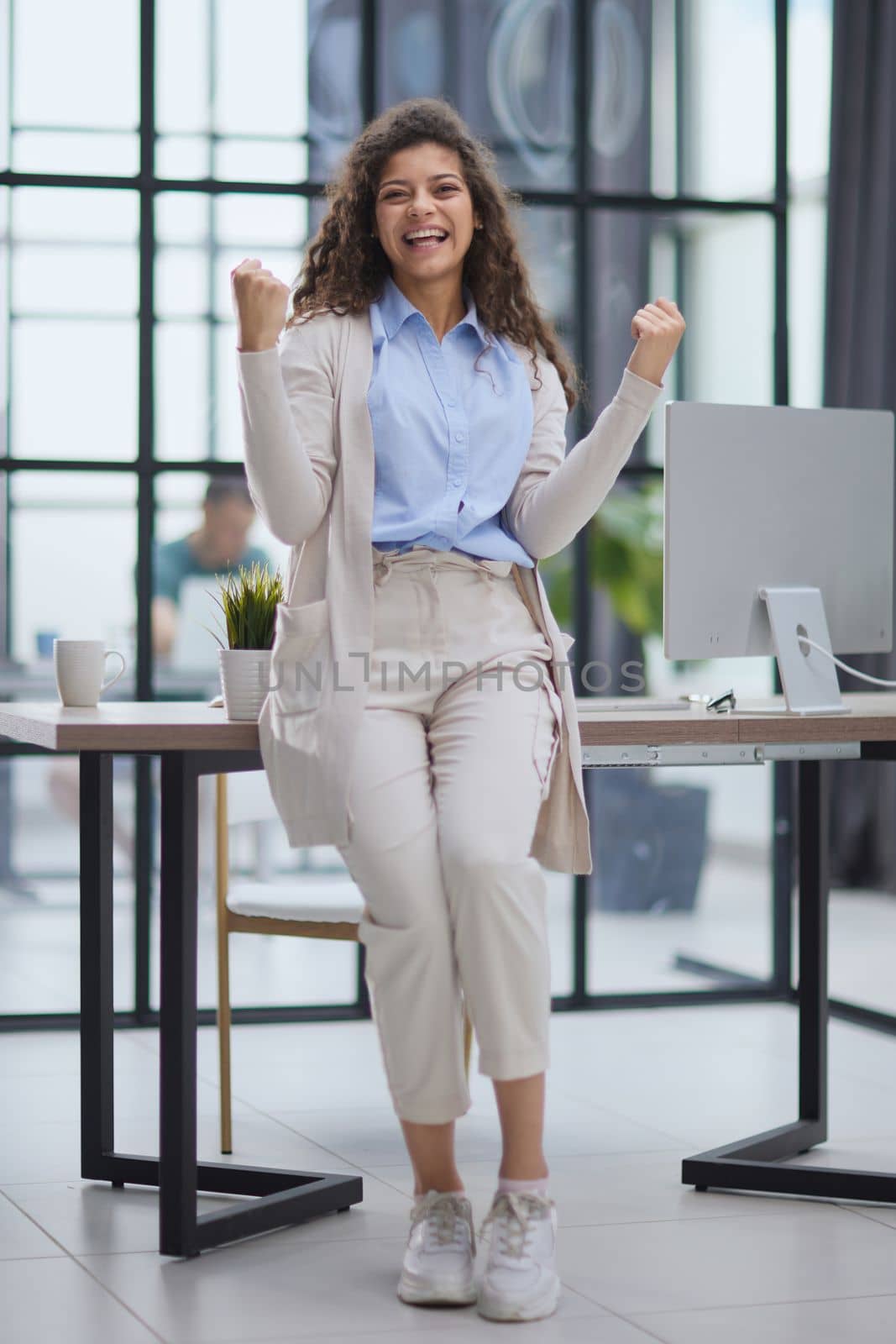 Excited young girl celebrating success business achievement result, looking camera