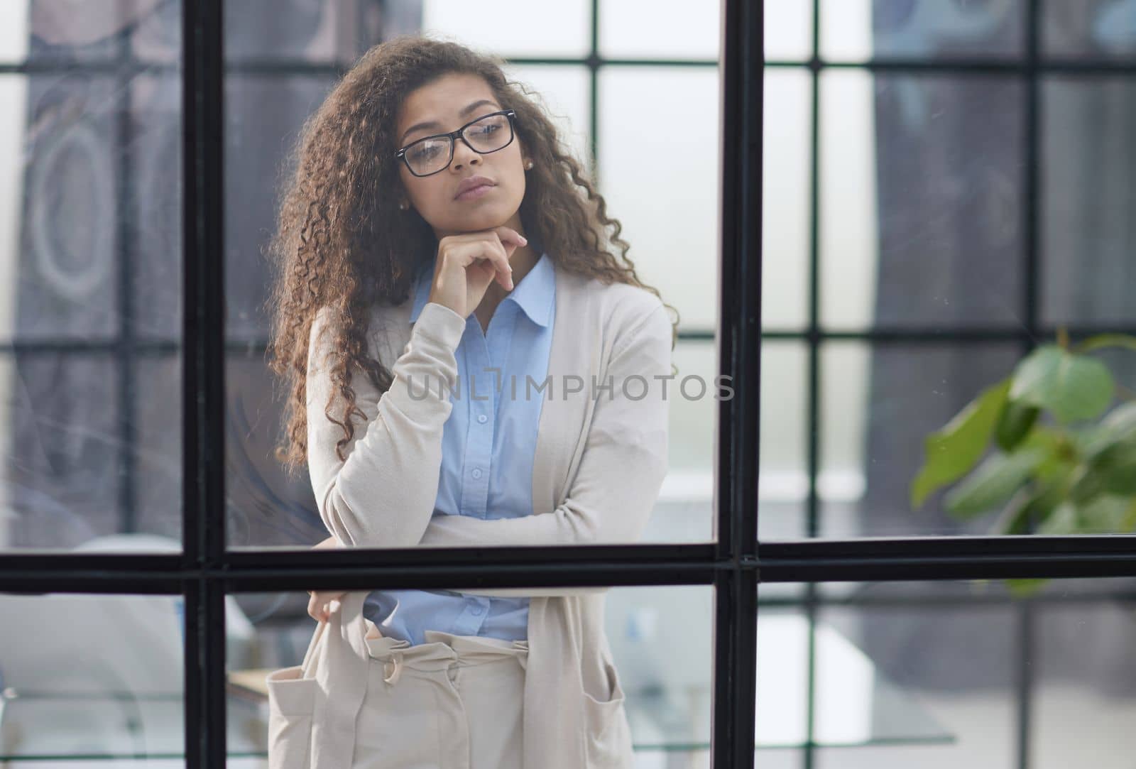 Business woman in the office outside the window