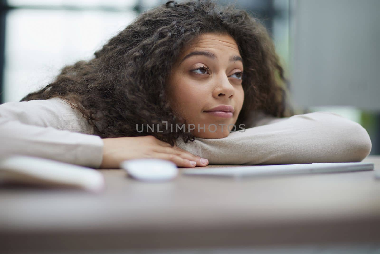 Portrait of a beautiful business woman sleeping on the table in the office