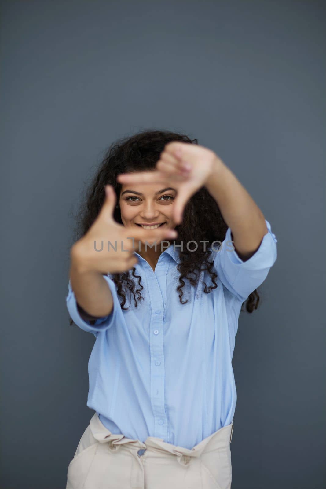 Photo of cheerful self-assured lady folded arms wear blue shirt grey color background