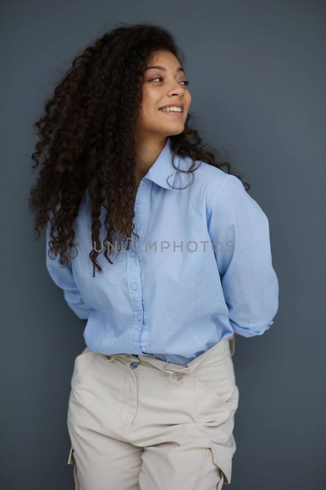 Photo of cheerful self-assured lady folded arms wear blue shirt grey color background