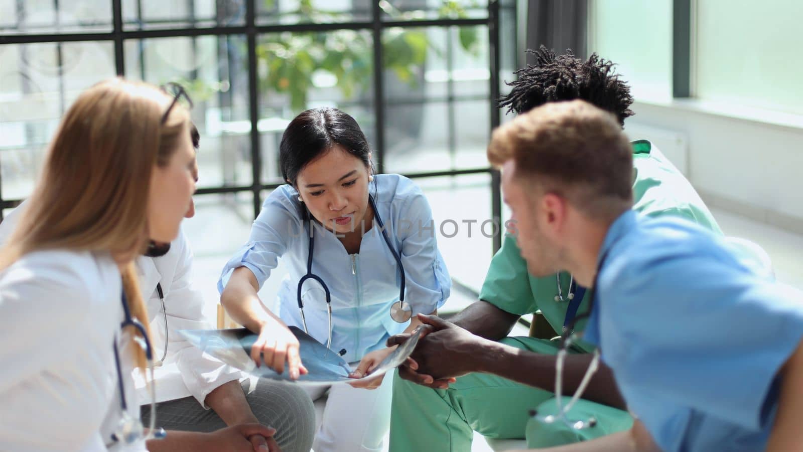 Group of multiethnic doctors looking at x-ray