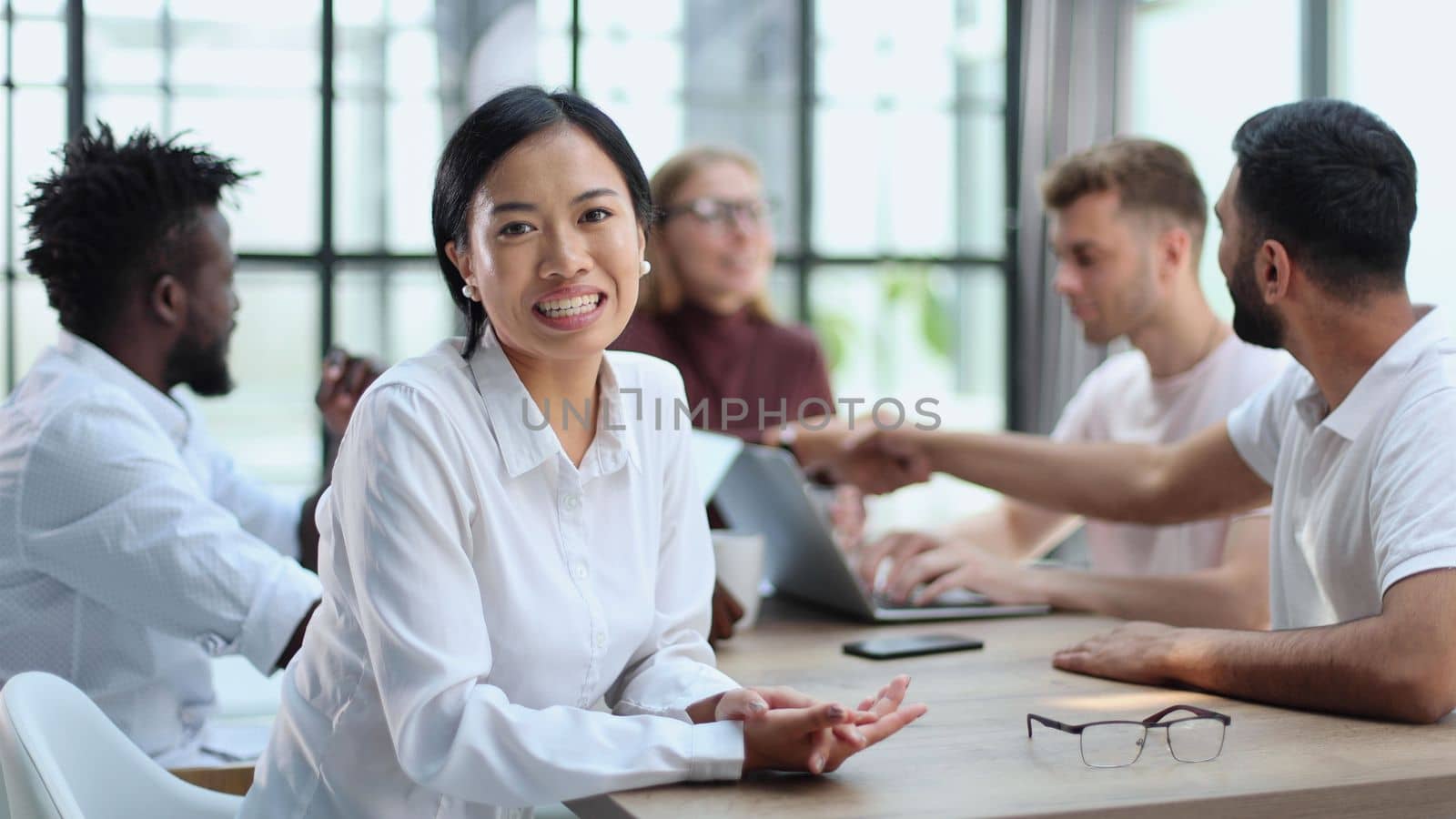 Happy young woman and looking at the camera. Portrait of a smiling businesswoman