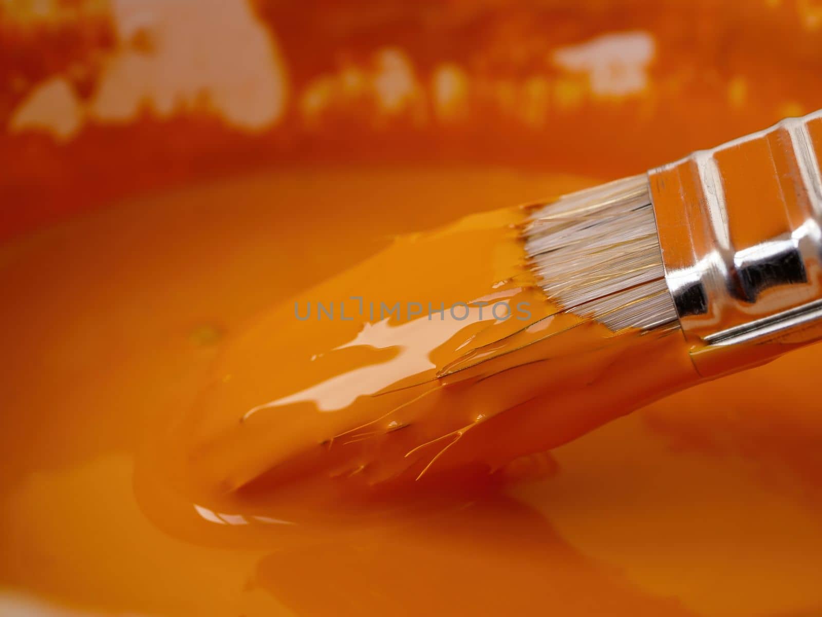 Close-up of a brush in can of paint as a home renovation concept.