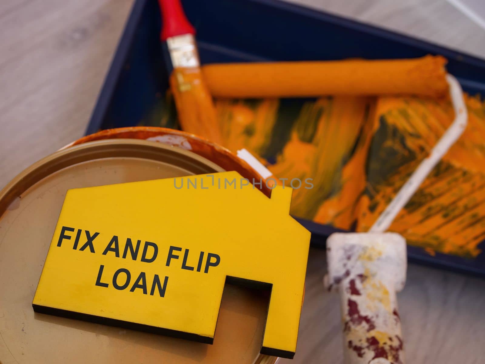 Fix and flip loan inscription, a can of paint and brush.