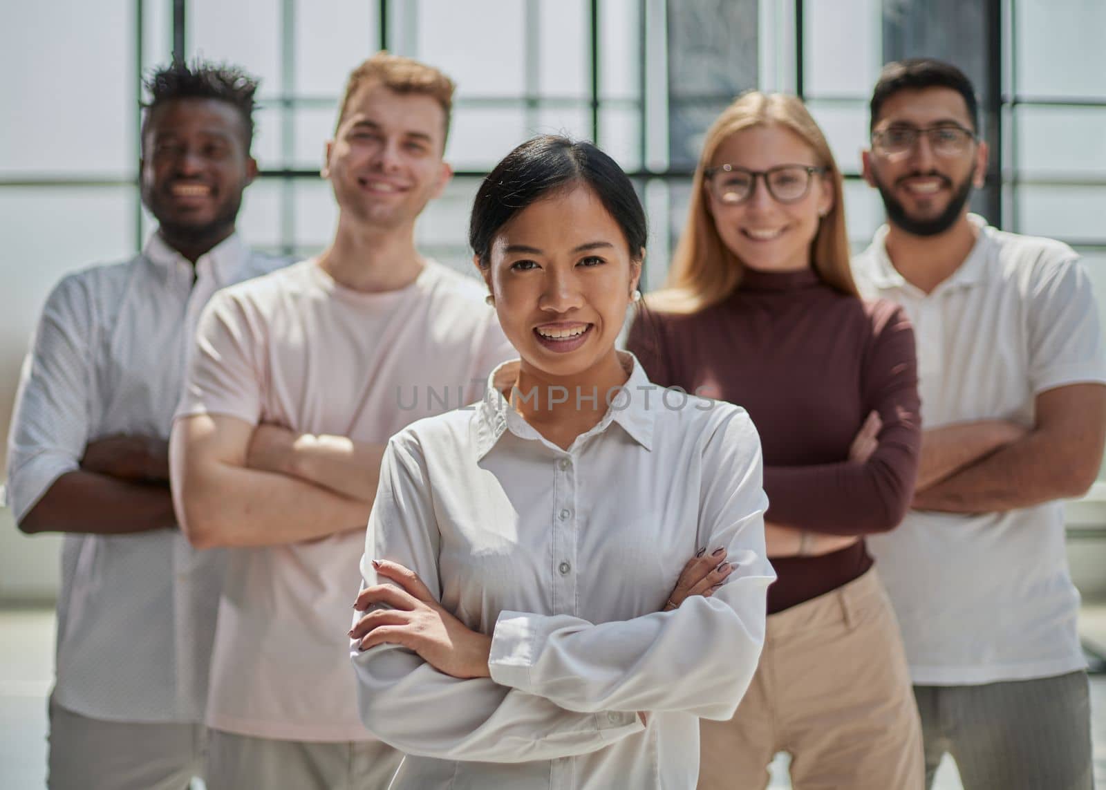 Portrait of creative business team standing together and laughing. Multiracial business people together