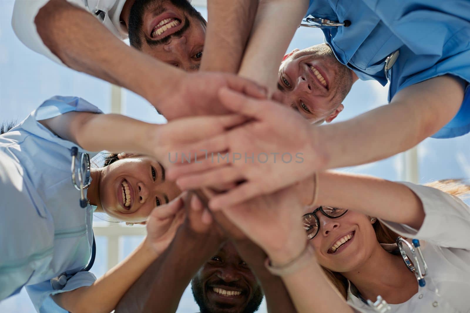 Professional Doctors Holding Each Other Hands. Multinational Medician Meeting.